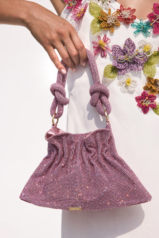 Detail shot of a pink, rhinestone bag.